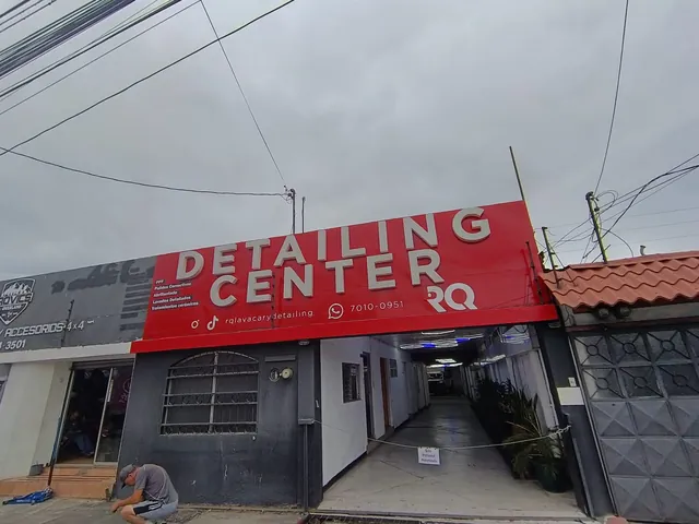 Fachada del Detailing Center con rótulo rojo, vista frontal